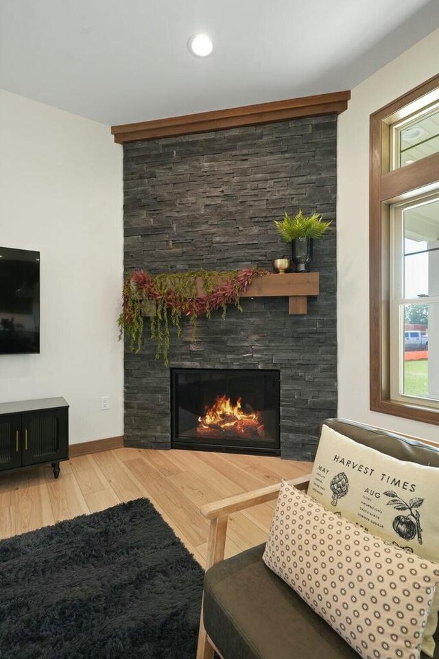 8437 Creek View Ln, Mount Pleasant, WI 53406 - living room with a stone fireplace, baseboards, wood finished floors, and recessed lighting