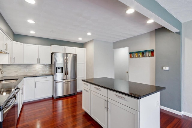 kitchen with decorative backsplash, stainless steel fridge with ice dispenser, baseboards, white cabinets, and dark wood-style floors