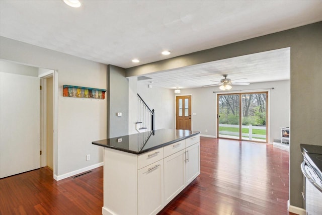 kitchen with white cabinets, recessed lighting, open floor plan, visible vents, and dark wood-style floors