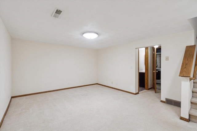 unfurnished room with baseboards, visible vents, light carpet, and stairway