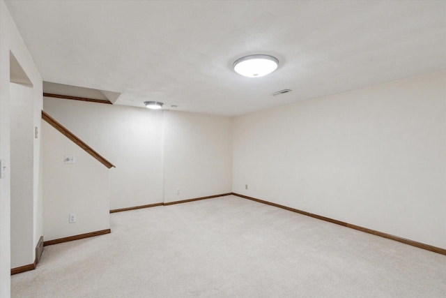 finished basement featuring baseboards and light colored carpet