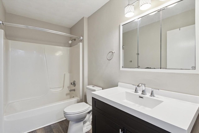full bath featuring vanity, tub / shower combination, wood finished floors, and toilet