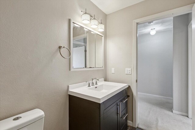 bathroom featuring vanity and toilet