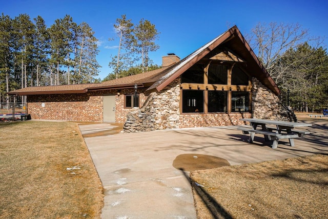 562 Feather Trl, Nekoosa, WI 54457 - view of front of property with a chimney and a patio area