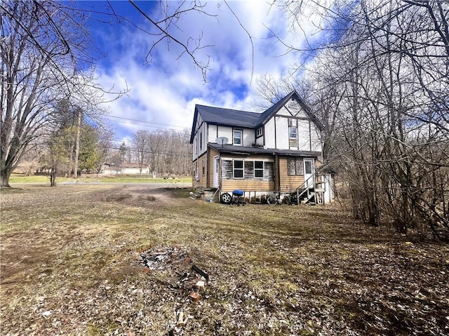 view of side of home featuring entry steps