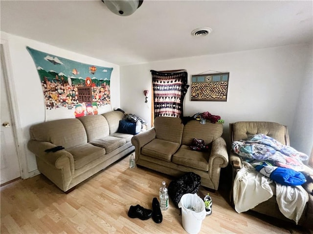 living room with light wood-type flooring and visible vents