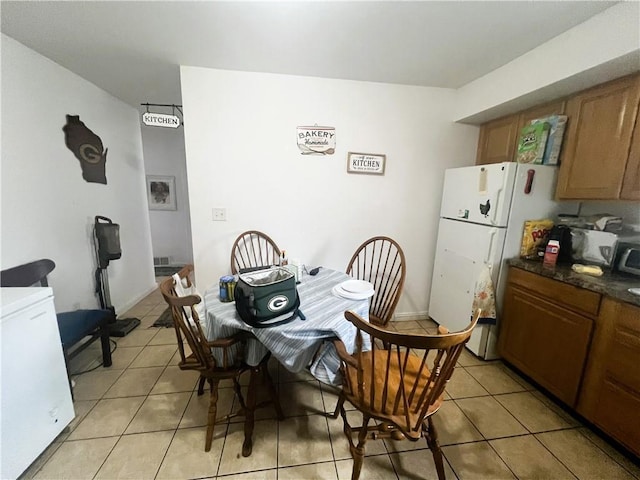 dining area featuring light tile patterned flooring