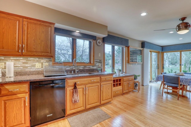 kitchen featuring dishwasher, ceiling fan, a healthy amount of sunlight, and stone counters