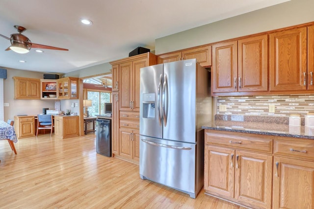 kitchen with built in study area, stainless steel fridge with ice dispenser, backsplash, light wood-style flooring, and ceiling fan