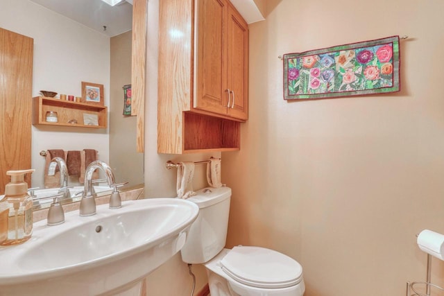 half bath with toilet and a sink
