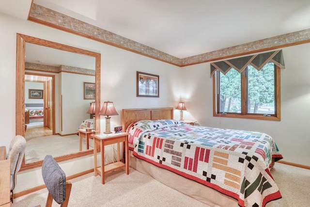 bedroom with baseboards and carpet