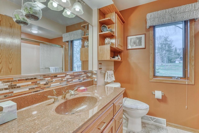 full bath featuring toilet, visible vents, decorative backsplash, a shower stall, and vanity