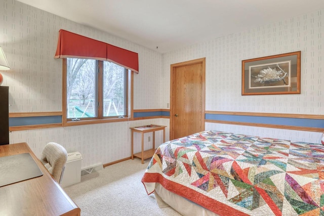 bedroom featuring wallpapered walls, carpet, and wainscoting