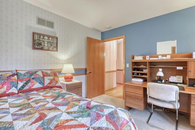 bedroom featuring carpet floors, wallpapered walls, and visible vents