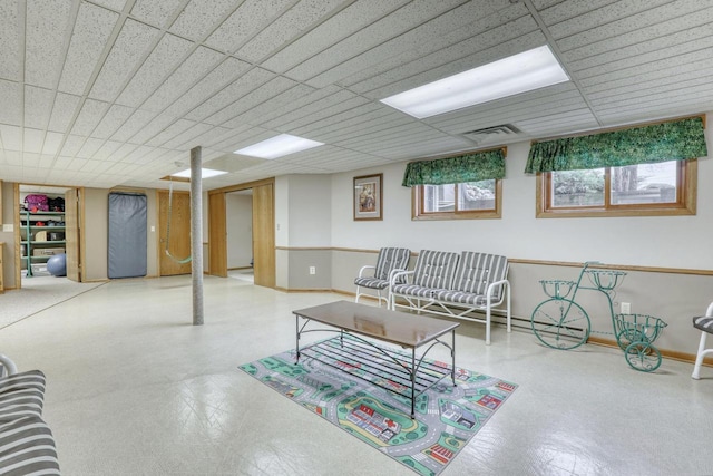 living area with tile patterned floors, baseboards, and visible vents