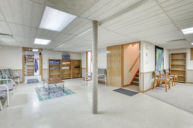 finished basement with stairs and visible vents