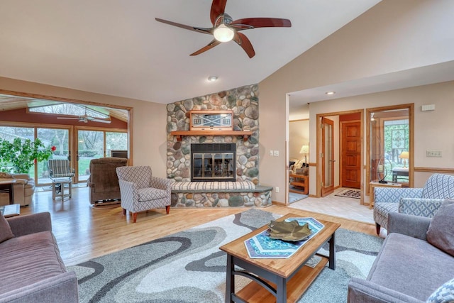 living area with ceiling fan, lofted ceiling, and wood finished floors
