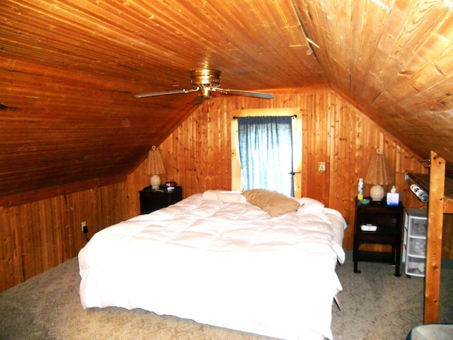 bedroom with wooden walls, vaulted ceiling, and carpet floors