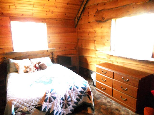 bedroom featuring wooden ceiling, lofted ceiling, and multiple windows