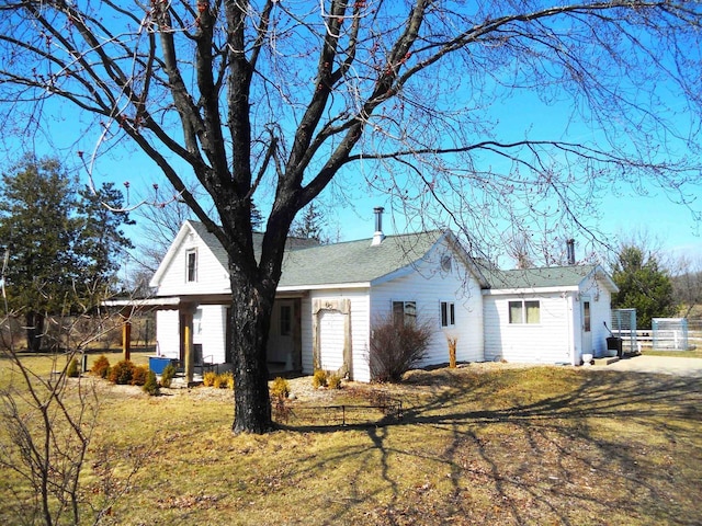 back of house with a lawn and fence