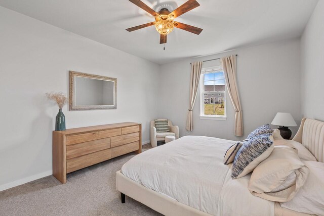 carpeted bedroom with baseboards and ceiling fan