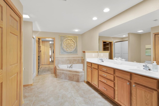 full bathroom featuring a shower stall, double vanity, a bath, and a sink