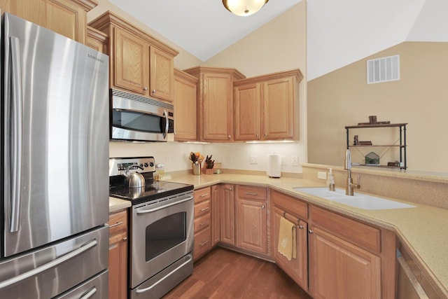 kitchen featuring a sink, visible vents, stainless steel appliances, light countertops, and vaulted ceiling