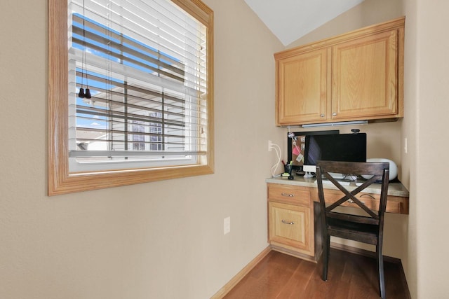 office with built in desk, lofted ceiling, wood finished floors, and a healthy amount of sunlight