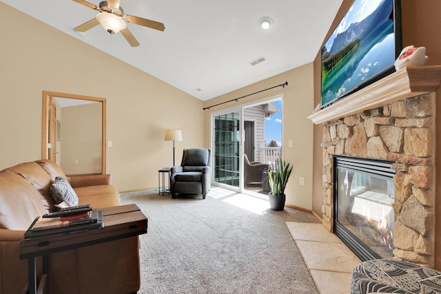 living area with light carpet, a stone fireplace, visible vents, a ceiling fan, and lofted ceiling