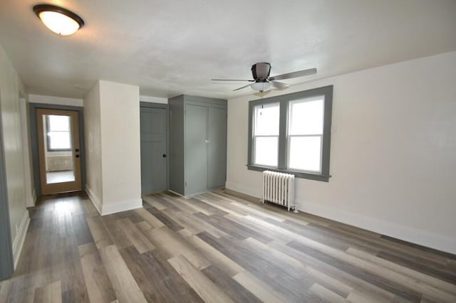 3736 E Edgerton Ave, Cudahy, WI 53110 - interior space with baseboards, radiator heating unit, a ceiling fan, wood finished floors, and a closet