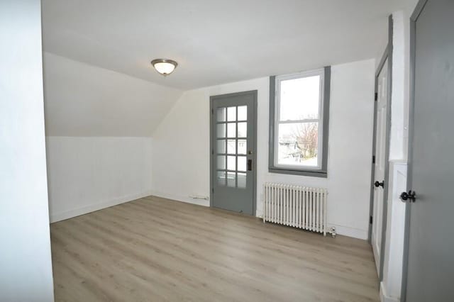 3736 E Edgerton Ave, Cudahy, WI 53110 - additional living space featuring vaulted ceiling, radiator heating unit, baseboards, and wood finished floors