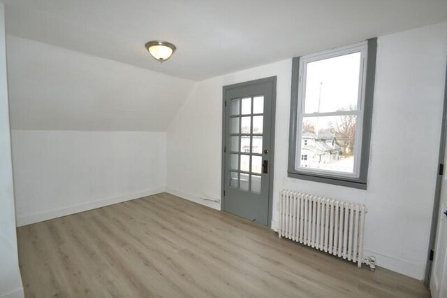 3736 E Edgerton Ave, Cudahy, WI 53110 - bonus room with lofted ceiling, radiator heating unit, wood finished floors, and baseboards