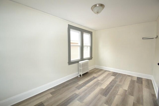3736 E Edgerton Ave, Cudahy, WI 53110 - spare room with radiator, wood finished floors, and baseboards
