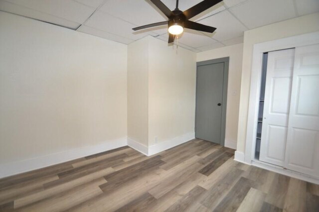 3736 E Edgerton Ave, Cudahy, WI 53110 - unfurnished bedroom featuring wood finished floors, a closet, a drop ceiling, ceiling fan, and baseboards