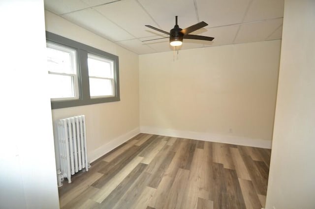 3736 E Edgerton Ave, Cudahy, WI 53110 - empty room featuring a paneled ceiling, baseboards, a ceiling fan, and radiator