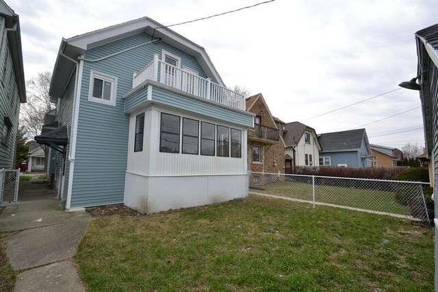 3736 E Edgerton Ave, Cudahy, WI 53110 - view of side of property with fence, a yard, and a balcony