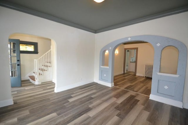 3736 E Edgerton Ave, Cudahy, WI 53110 - spare room with radiator heating unit, wood finished floors, baseboards, and arched walkways