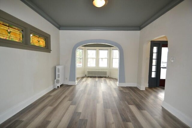 3736 E Edgerton Ave, Cudahy, WI 53110 - interior space featuring radiator, arched walkways, and a healthy amount of sunlight