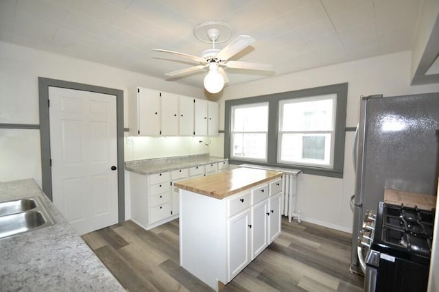 3736 E Edgerton Ave, Cudahy, WI 53110 - kitchen with dark wood finished floors, butcher block countertops, white cabinetry, gas stove, and ceiling fan