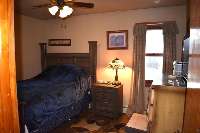 71435 Range Line Rd, Iron River, WI 54847 - bedroom featuring baseboard heating, wood finished floors, and a ceiling fan