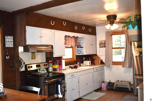 71435 Range Line Rd, Iron River, WI 54847 - kitchen featuring ceiling fan, under cabinet range hood, electric stove, and a healthy amount of sunlight