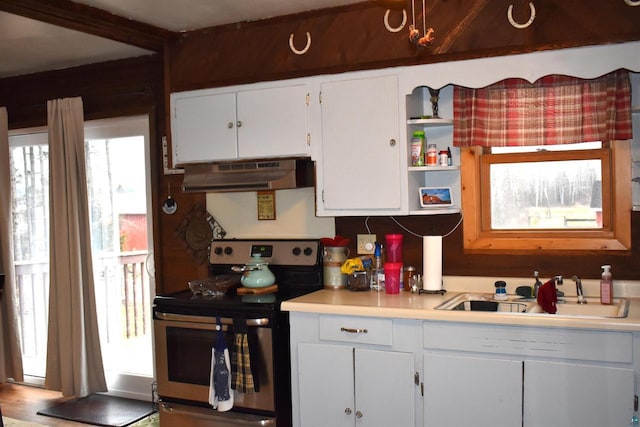 71435 Range Line Rd, Iron River, WI 54847 - kitchen with a sink, stainless steel range with electric cooktop, white cabinetry, light countertops, and under cabinet range hood
