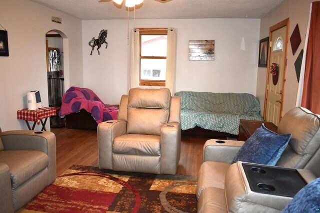 71435 Range Line Rd, Iron River, WI 54847 - living area featuring a ceiling fan, wood finished floors, and arched walkways