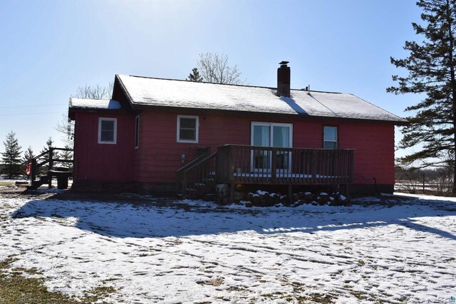 71435 Range Line Rd, Iron River, WI 54847 - snow covered rear of property featuring a wooden deck and a chimney