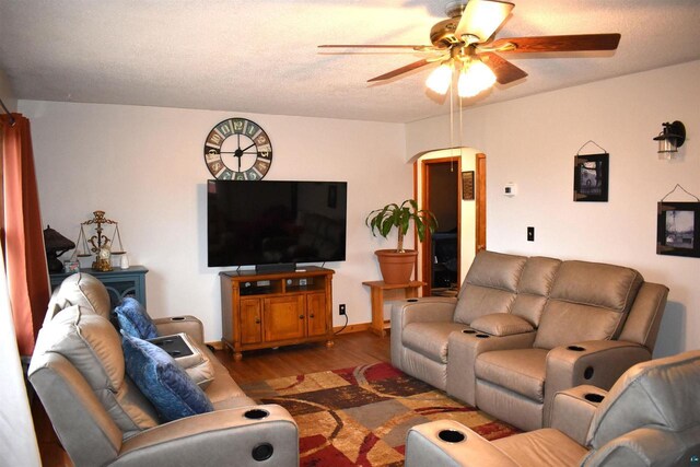 71435 Range Line Rd, Iron River, WI 54847 - living area featuring arched walkways, wood finished floors, and a ceiling fan