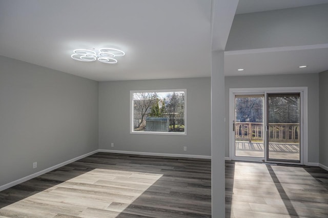 2941 Chapel Ln, Mount Pleasant, WI 53406 - unfurnished room with wood finished floors, a wealth of natural light, and baseboards
