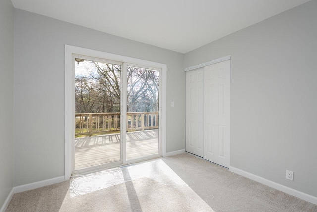 2941 Chapel Ln, Mount Pleasant, WI 53406 - unfurnished bedroom with light colored carpet, baseboards, access to outside, and a closet