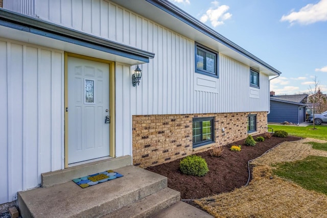 2941 Chapel Ln, Mount Pleasant, WI 53406 - doorway to property featuring brick siding and board and batten siding