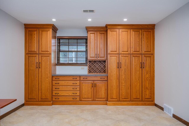 2941 Chapel Ln, Mount Pleasant, WI 53406 - kitchen with brown cabinets, visible vents, and baseboards