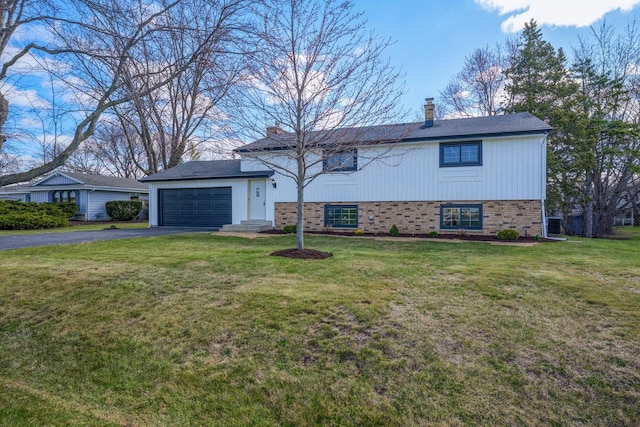 2941 Chapel Ln, Mount Pleasant, WI 53406 - tri-level home featuring brick siding, driveway, a chimney, and a front lawn